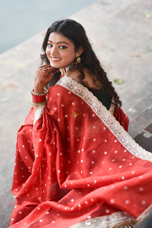 Red banarasi handwoven tissue silk saree with small zari weaving all over saree comes with beautiful pearl lace border
